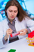 Scientist writing on test tube