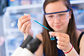 Chemistry student using pipette