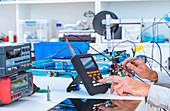 Person working in electronics laboratory