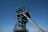 Mine shaft lift against clear blue sky