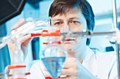 Woman doing experiment in chemical laboratory