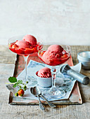 Strawberry yoghurt ice cream in a strawberry wine sauce