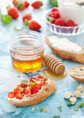 Strawberries, mint and hazelnuts on mascarpone toast with honey