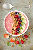 A smoothie bowl with granola, berries and banana