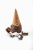 A chocolate-covered ice cream cone tipped upside down