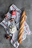 Burrata (a fresh Italian cheese made from mozzarella and cream) served with baguette and pomegranate