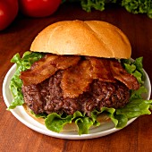 A hamburger with bacon and lettuce