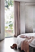 Bedroom in shades of gray with floor-to-ceiling window