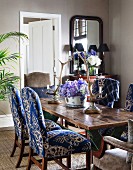 Upholstered chairs and antler candlesticks in dining room
