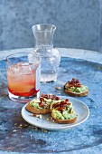 A Lillet Lacanau cocktail served with crostini with courgette spread and sun-dried tomatoes