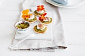 Pesto toasts topped with trout and nasturtium flowers