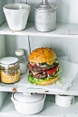 A double burger with beef, maasdam cheese, Joppiesaus mayo, pickled cucumbers, and onions