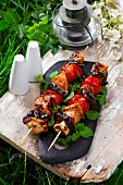 Grilled chicken skewers with aubergine and tomato