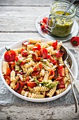 Fusilli salad with fresh cherry tomatoes, roasted peppers and pesto