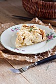 Slice of a rustic apple pie with rosemary