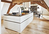 An elegant kitchen island under wooden beams