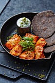 Spicy chicken pieces with flatbread