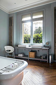 Large bathroom in period building with two sinks on long washstand