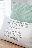 Hand-made cushion cover with printed and embroidered motto