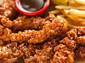 Crispy breaded chicken strips with French fries