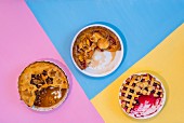 Three different fruit pies, sliced