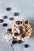 Waffles with banana and blueberry, dusted with powdered sugar