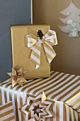 Christmas gifts decoratively wrapped in gold paper with hand-made bow