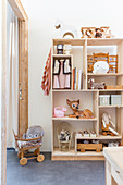 Shelves with compartments of various sizes in children's bedroom