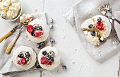 Meringue nests with raspberries and blueberries and whipped cream