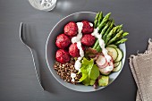 A beet falafel, quinoa, asparagus, radish, cucumber and yogurt dressing bowl