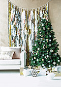 Garland with tinsel and tassels behind the Christmas tree