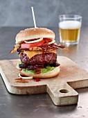 A beef burger with cheddar, bacon and BBQ sauce