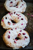 Three doughnuts sprinkled with dried rose petals