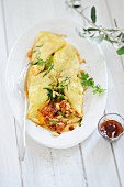 Omelette stuffed with pine nuts and herbs