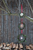 Garland of three wreaths with straw stars hung from tree