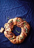 A brioche wreath with nuts, chocolate and rosemary