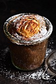 Apple cake in a glass dusted with powdered sugar