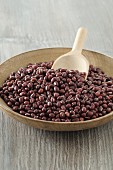 Azuki beans in a wooden bowl with a scoop