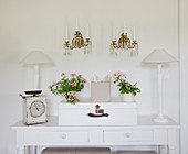 Flowers and ornaments arranged symmetrically on console table