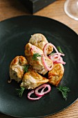 Chicken on plate with onions and garnish