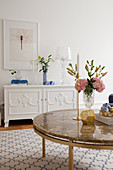 Vase of flowers on coffee table in elegant living room
