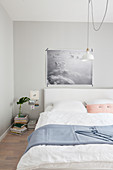 Poster of clouds above bed in pastel bedroom