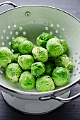 Freshly washed brussels sprouts in a colander