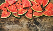 Juicy watermelon pieces over rustic wooden background