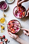 Berry smoothie bowls with hibiscus and cashew butter (top view)