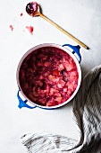 An apple and cranberry sauce in a pan