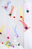 Garland of Easter bunnies cut out of various wallpaper remnants