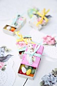 Sugar eggs in matchboxes covered in coloured paper as gifts