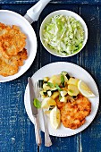 Turkey schnitzel with fried poatato and courgette, cabbage slaw