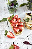Open sandwiches topped with strawberries and peanut butter, and pear slices